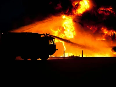 A fire truck putting out a wild fire